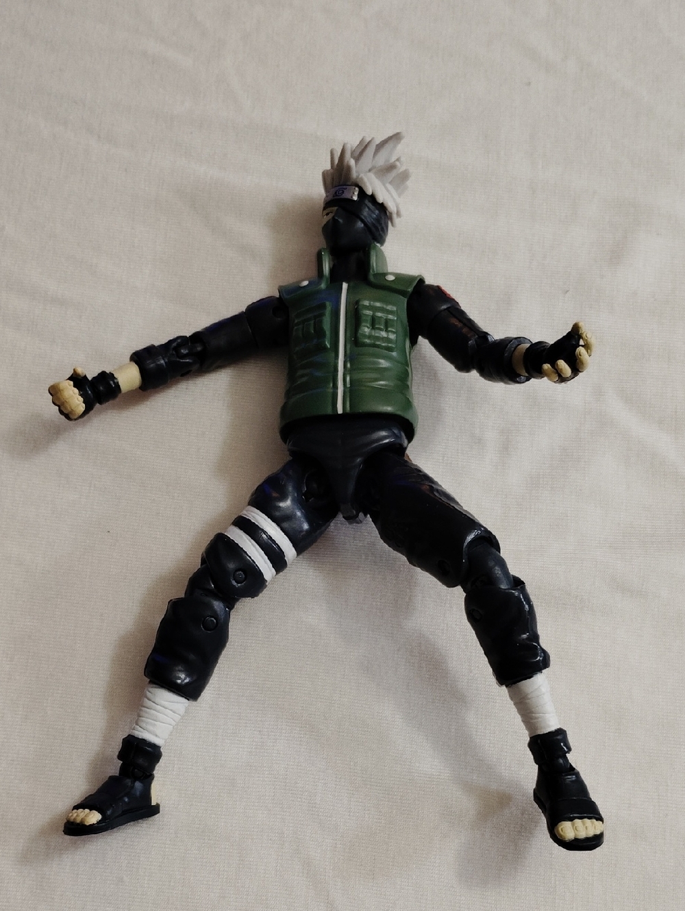 Action Figure with Green Vest and Black Outfit